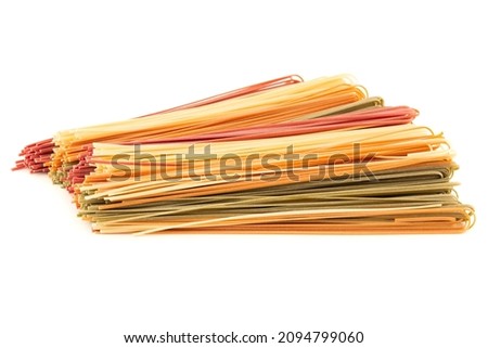 The heap of Italian vegetable flat pasta isolated on white background. Horizontal view. Closeup picture.