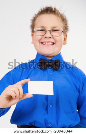 Young well-dressed boy holding an empty advertising card
