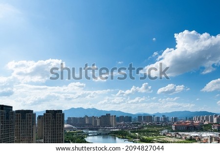 City by the sea under blue sky.