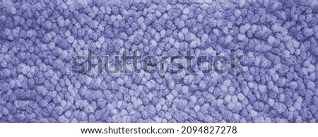 The background of fluffy material in the new trendy color of 2022 year Very Peri. Texture top view. Blog backdrop for text signs design. Abstract wallpaper, textile surface.