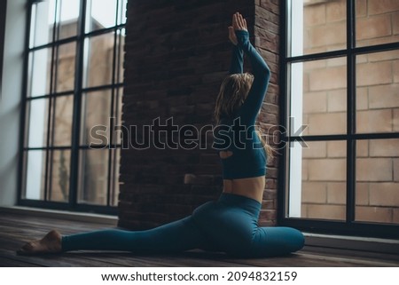 Woman practices yoga in the studio. High quality photo