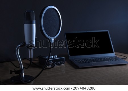 Condenser microphone and laptop. Podcast concept.