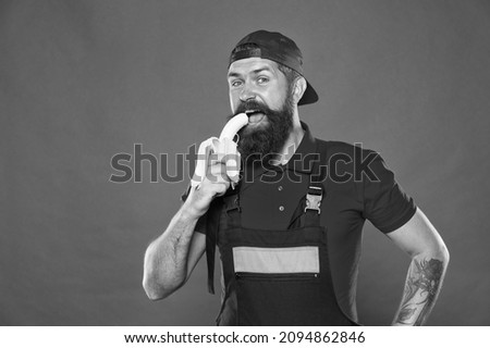 Living healthy life. Hungry hipster eat favorite food. cheerful worker eating banana. fresh organic fruit. healthy food and dieting. Good healthcare nutrition concept. tasty seduction Royalty-Free Stock Photo #2094862846