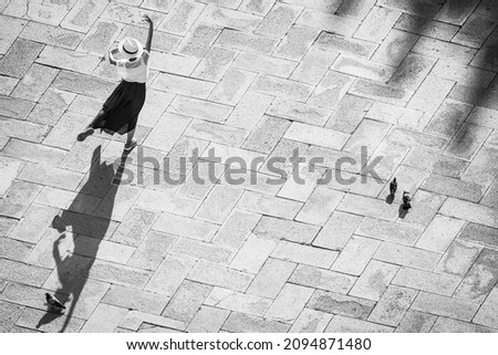 Europe, Italy, Venice. Black and white of tourist poising for photo on San Marco Square.