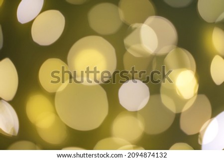 Festive yellow background with different sized bright glowing lights. Interesting close-up concept.