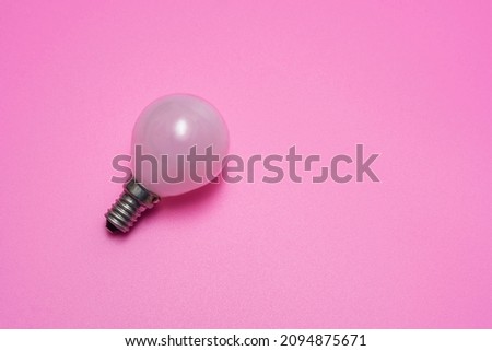 White minion light bulb on pink background