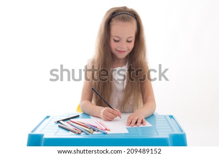 Little girl drawing using color pencils isolated on white background