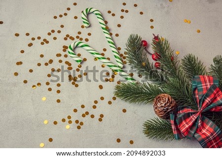 christmas concrete background with fir twigs and sequins , the concept of Christmas and Christmas sales