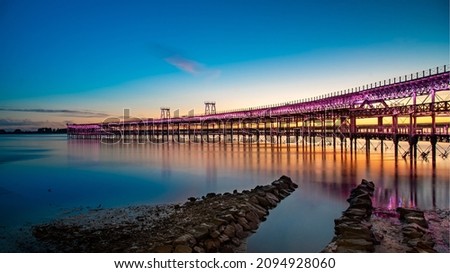 Panoramic view of the ore loading dock of the Rio Tinto mining company in Huelva, Andalusia, Spain. Sunset at the "Muelle del Tinto" Royalty-Free Stock Photo #2094928060