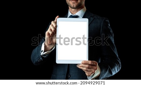 Screen mockup. Empty blank tablet in businessman hand. Mock up screen smart device isolated on black banner background. Game design, mobile application presentation or portfolio mockups.