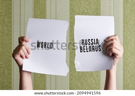 World against Russia and Belarus. Torn paper with World on one side and Russia-Belarus coalition on the other side. Modern developed world against dictatorship in Russia and Belarus Royalty-Free Stock Photo #2094941596