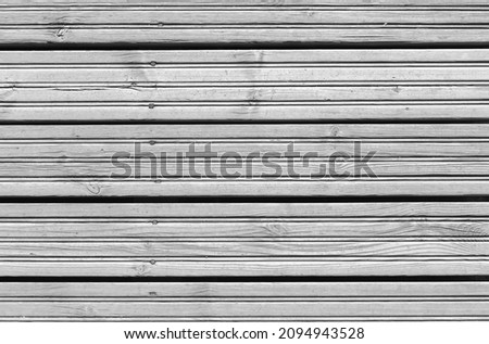 Background texture of gray wooden floor made of rough larch boards, top view