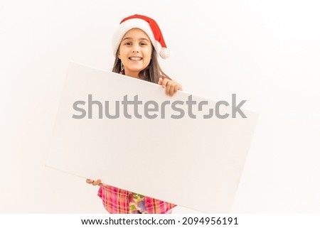 Christmas girl standing with empty horizontal blank in hands, above view, isolated on white