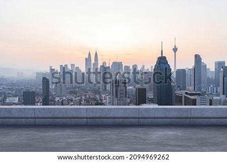 Panoramic Kuala Lumpur skyline view, concrete observatory deck on rooftop, sunset. Asian corporate and residential lifestyle. Financial city downtown, real estate. Product display mockup empty roof Royalty-Free Stock Photo #2094969262