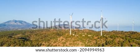 Carbon neutral and Renewable Energy wind farm Wind Turbines. Green and renewable power concept. Wide photo