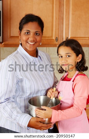 Girl and mother cooking in the kitchen