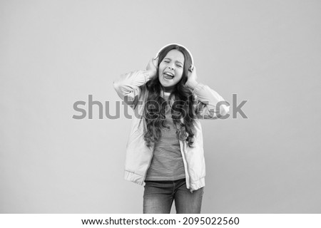 Joining in a song. Small girl sing to song pink background. Little child do vocal on song. Emotional singer. Enjoying song playing in headphones. Karaoke and entertainment. Singing along to tune Royalty-Free Stock Photo #2095022560