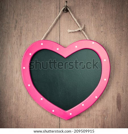 Love heart sign board on wooden vintage wall background