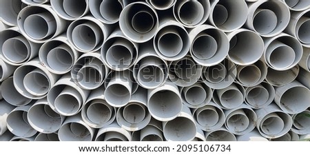 This is a pile of dirty  white PVC pipes with a fairly large diameter.