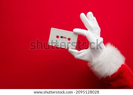 Father Christmas holding a retro music cassette tape. Christmas party concept