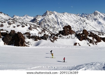 Winter season. Skiers on the ski slope in the Caucasian mountains. Selective focus 
