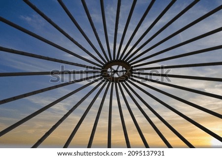 An abstract picture of an arc with a beautiful sky and sunset in the background