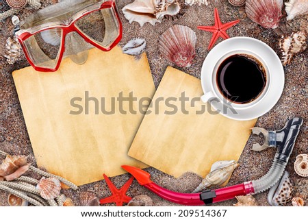 Marine items and grungy paper on sand background