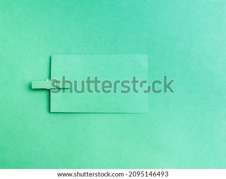 For background purpose with green color blank paper and clothspin.