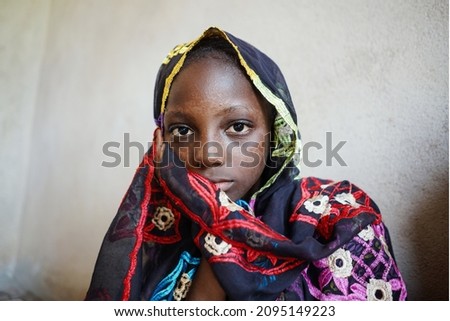 Scared little african girl going to be married to an unknown man; forced or arranged and child marriage concept for women’s and girl’s rights Royalty-Free Stock Photo #2095149223