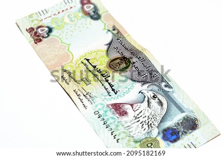 Obverse side of 500 AED five hundred Dirhams banknote of United Arab Emirates money bill, currency of the UAE with a picture of Sparrowhawk at right, selective focus, isolated on white background