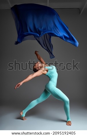 Ballerina Dancing with Silk Fabric, Modern Ballet Dancer in Fluttering Waving Cloth, Gray Background