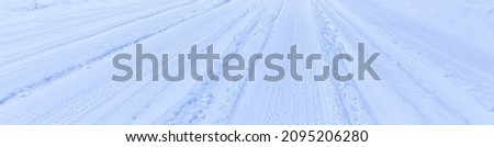 Texture of a snowy road with traces of car tires. Winter driving concept.                     