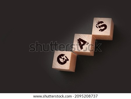 Gas -word on wooden cubes with letters on black. Energy gas oil economy concept.