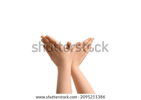 Child performing a shadow play on white background