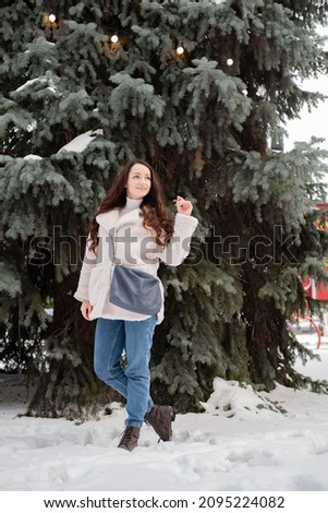Portrait of young beautiful brunette outdoors. winter concept.