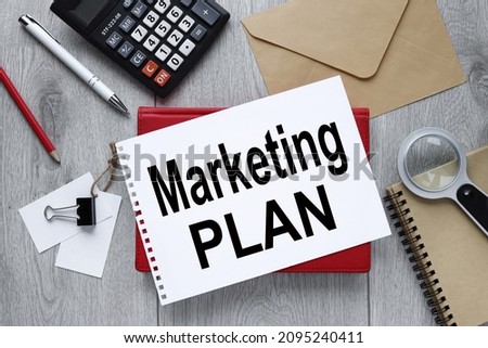 Marketing Plan Business Advertising. Office desk with blank notepad and calculator. Open notebook page