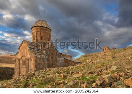 Ani site of historical cities (Ani Harabeleri): first entry into Anatolia, an important trade route Silk Road in the Middle Agesand. Historical Church and temple at sunset in Ani, Kars, Turkey. Royalty-Free Stock Photo #2095242364