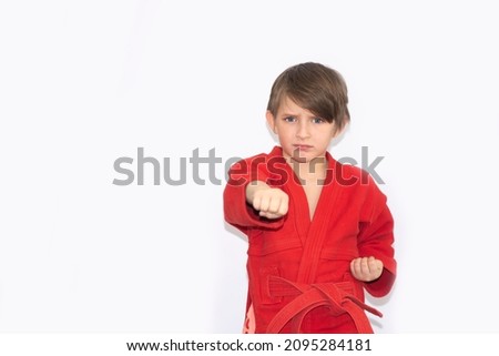 boy in wrestling tracksuit making fist punch forward