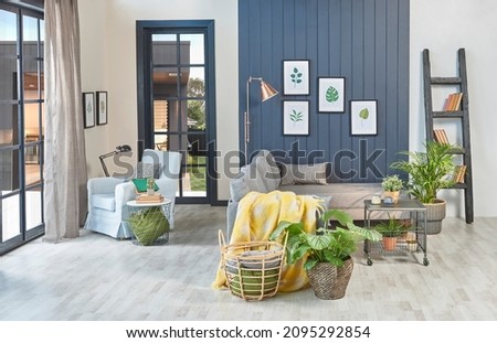 Modern blue room, grey sofa, yellow blanket and leaf frame, lamp, home decoration and parquet style.