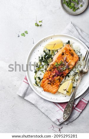 grilled salmon steak with lemon rice and spinach Royalty-Free Stock Photo #2095295281