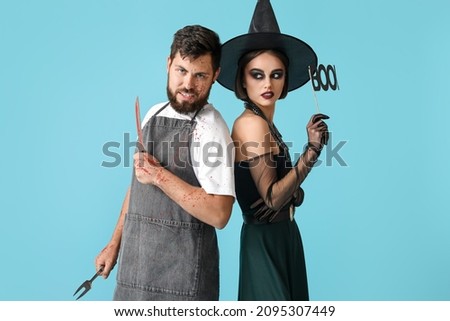 People in Halloween costumes on color background