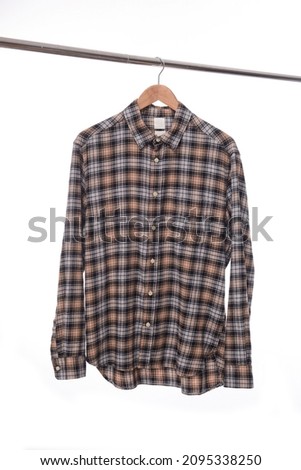 checkered shirt or plaid shirt
 on hanger 

