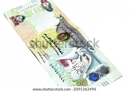 Obverse side of 500 AED five hundred Dirhams banknote of United Arab Emirates money bill, currency of the UAE with a picture of Sparrowhawk at right, selective focus, isolated on white background