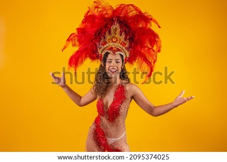 Brazilian afro woman posing in samba costume over yellow background with free space. Brazilian dressed Samba costume.
