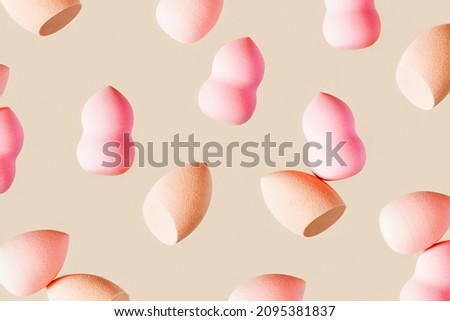 Pattern with cosmetic sponge pink beige colored. Soft makeup sponge beauty blender, brush for face skin, facial applicator. Backgrounds for salon fashion beauty makeup. Neutral pastel color.