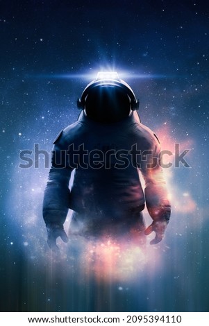 Epic view of an astronaut or cosmonaut in spacesuit in space with stars, nebula and galaxy around him. Sci-fi and fantasy theme. Stars in the image furnished by NASA. 3D rendering. Royalty-Free Stock Photo #2095394110