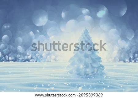 Winter decorations. White fir tree candle in snowing background. Christmas celebration