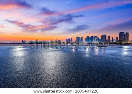 Panoramic skyline and modern commercial buildings with empty road. Asphalt road and cityscape at sunrise Royalty-Free Stock Photo #2095407220