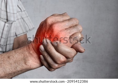 Pain in the hand of Southeast Asian elder man. Concept of hand pain, arthritis and tendon problems.