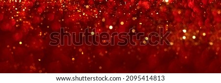 Red and golden sparkling glitter bokeh background. Holiday lights. Abstract defocused header. Wide screen wallpaper. Panoramic web banner with copy space for your design